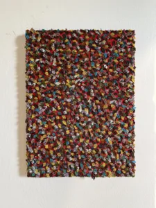 Gum Wall Tactile Textured Squeeze — abstract oil-and-wax painting; hundreds of piped impasto dabs in yellow, blue, white, green and brown covering a red ground — detail 3 of 3, close-up of surface texture