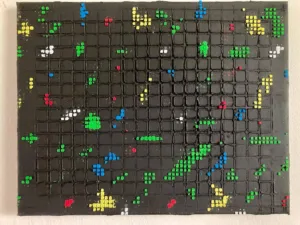 Physical Pixel Abstraction In Green Red White And Yellow On Black Background — painting; structured on a grid — detail 2 of 3, close-up of surface texture