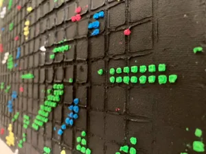 Physical Pixel Abstraction In Green Red White And Yellow On Black Background — painting; structured on a grid — detail 3 of 3, close-up of surface texture