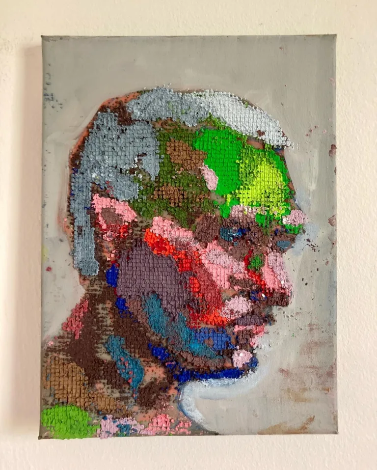 Physical Pixel Portrait Male Side Profile — grid-based oil-and-wax portrait; a man's head in profile built from raised square pixels in green, pink, gray, blue and brown on a pale gray ground