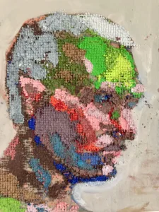Physical Pixel Portrait Male Side Profile — grid-based oil-and-wax portrait; a man's head in profile built from raised square pixels in green, pink, gray, blue and brown on a pale gray ground — detail 1 of 2, close-up of surface texture