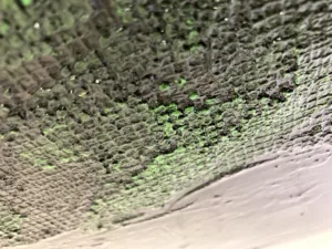 Physical Pixel Portrait Neo Matrix — painting; structured on a grid; in oil on canvas; green and black tones — detail 3 of 3, close-up of surface texture