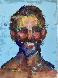 Physical Pixel Portrait Of A Man Smiling On Blue Background — grid-based oil-and-wax portrait; a smiling man built from raised square pixels of brown, pink and yellow paint on pale blue — detail 2 of 2, close-up of surface texture