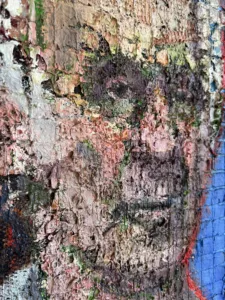 Physical Pixel Portrait Of Man With White Hair — painting; structured on a grid; in oil on canvas; red and blue tones — detail 5 of 5, close-up of surface texture