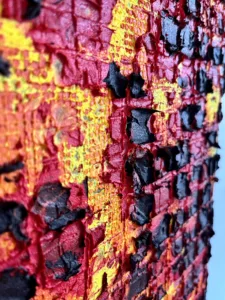 Physical Pixel Tactile Fire — painting; structured on a grid; in oil on canvas; black, orange and red tones — detail 1 of 3, close-up of surface texture