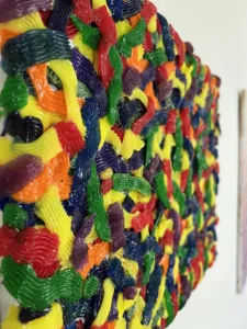 Tactile Candy Relief Squeeze 1 — abstract acrylic-and-gel relief; interlocking piped ribbons of red, yellow, green, blue, purple and orange covering the canvas edge to edge — detail 3 of 9, close-up of surface texture