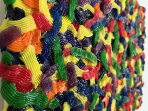 Tactile Candy Relief Squeeze 1 — abstract acrylic-and-gel relief; interlocking piped ribbons of red, yellow, green, blue, purple and orange covering the canvas edge to edge — detail 6 of 9, close-up of surface texture