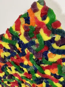 Tactile Candy Relief Squeeze 1 — abstract acrylic-and-gel relief; interlocking piped ribbons of red, yellow, green, blue, purple and orange covering the canvas edge to edge — detail 8 of 9, close-up of surface texture