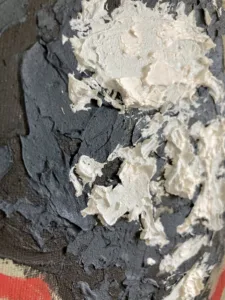 Tactile Four Value Black And White Relief Portrait In Black And White With Red Outline — oil-and-wax relief portrait; black and thick white impasto head on olive ground, traced by a red contour line — detail 2 of 3, close-up of surface texture