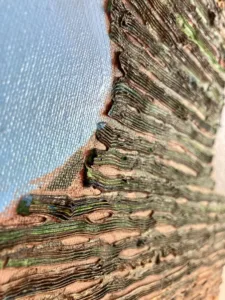 Tactile Textured Linear Squeeze Portrait Of A Man — oil-and-wax relief portrait; a head built from stacked horizontal ridges in green, yellow and brown against blue and violet — detail 2 of 4, close-up of surface texture