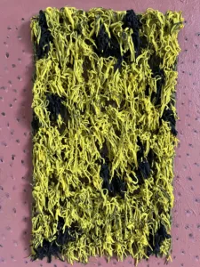 Tactile Textured Squeeze Mohawk — abstract oil-and-wax relief; a dense rectangle of yellow and black piped strands on a dotted rose-brown ground — detail 1 of 5, close-up of surface texture