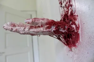 Youre Back — painted relief; of a single figure; built up in heavy, tactile impasto; in spray paint; red and white tones — detail 3 of 3, close-up of surface texture